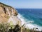 Dume Cove Malibu Beach, view from Dume Point overlook at Zuma Beach, emerald and blue water in a quite paradise beach surrounded b