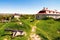 The dummy cannon on the hill in Zolochiv Castle. Sky with clouds and cityscape in the background