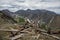 A dump for scrap metal and destroyed logs high in the mountains of the Kurai steppe. Landscape with mountain peaks