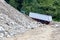 dump truck carrying boulders, pebbles and sand from the bottom of a mountain river