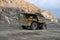 Dump truck Caterpillar carries ore through a career.