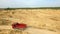 Dump truck driving on rural road. Scene. Top view of truck rides, leaving plumes of dust in dirt road in countryside on