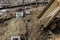 Dump truck dumps its load of rock and soil on road construction site the installed water drainage system