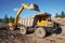 A dump truck in a mountainous wooded area. An industrial excavator loads rock into a dump truck.