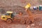 Dump truck tipping on a road construction site