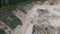 Dump truck transported sand from the open pit. Truck with tipper semi trailer working in quarry. Arial view of the opencast mine.