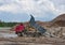 Dump truck unloading old concrete and asphalt from demolition for recycling. Landfill for disposal of construction waste. Gravel