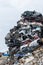 Dumping ground. Scrap metal heap. Compressed crushed cars is returned for recycling.