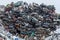 Dumping ground. Scrap metal heap. Compressed crushed cars is returned for recycling. Iron waste ground in the industrial area.