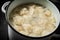 Dumplings are boiled in a saucepan in boiling water.