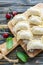 Dumplings with cherries on floured board.