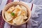 Dumplings, filled with mashed potato - vegetarian dish. Varenyky, vareniki, pierogi, pyrohy in a bowl on wooden table