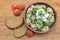 dumplings with fresh herbs and sour cream in a dish, cherry tomatoes and bread