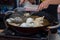Dumplings fried in hot oil pan