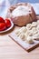 Dumplings with meat on a wooden stand - cooking, raw unpeeled dumplings, national Russian, Ukrainian cuisine.