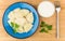 Dumplings with parsley, sour cream and fork on table