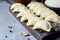 Dumplings with potatoes with herbs on a blue background. Varenyky, vareniki, pierogi, pyrohy - dumplings with filling.