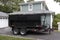 Dumpster on a trailer in a residential driveway