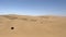 Dune driving in desert. White SUV car off road travel in Africa.