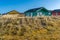 Dune, Germany - 02.27.2022: Colorful wooden cabins on sandy dunes with yellow grass on a beautiful sunny day of winter