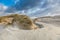 Dune scenery along Dutch North Sea coast with by wind power carved   deep holes with steep walls