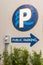 Dunedin, Florida, USA 11/8/19 A public parking arrow sign with a larger sign above it with P
