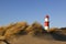 Dunes at Borkum beach and small lighthouse