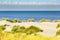 Dunes, clouds, sea and a blue sky