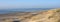 Dunes and almost deserted beach on dutch coast near renesse in zeeland under blue sky