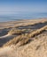 Dunes and almost deserted beach on dutch coast near renesse in zeeland under blue sky