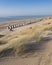 Dunes and almost deserted beach on dutch coast near renesse in zeeland under blue sky