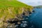 Dunquin or Dun Chaoin pier, Ireland\\\'s Sheep Highway. Aerial view of narrow pathway winding down to the pier