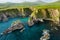 Dunquin or Dun Chaoin pier, Ireland\\\'s Sheep Highway. Aerial view of narrow pathway winding down to the pier