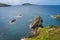 Dunquin Pier and harbour with tall cliffs, turquoise water and islands, Dingle, Wild Atlantic Way