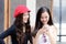 Duo asian portrait girl have playing a mobile phone and talking