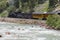 The Durango and Silverton Narrow Gauge Railroad Steam Engine travels along Animas River, Colorado, USA