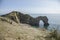 Durdle Door limestone arch, England - blue waters and meadows.