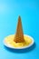 durian flavor ice cone melted on a dish on blue background