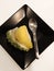 Durian ice cream in black plate.