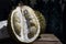 Durian Tropical Fruit cut in half wide open on dark background. portrait