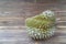 Durio zibethinus or Durian on brown jane wooden texture background