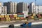 DURRES, ALBANIA - JULY 28, 2017: Small colorful boat in front of cargo containers of Durres harbor and urban skyscrapers, building