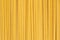 Durum fettuccine noodles background. Close up of raw spaghetti. Full frame of pasta