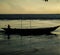 At dusk, a boatman was returning home with his boat.