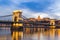 Dusk at bridge on Danube river with lights