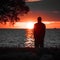 Dusk contemplation Mans silhouette against the Gulf of Finland sunset
