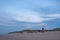 Dusk Descends on Beachgoers Near Coastal Lighthouse