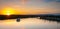 Dusk falls over the city and river as riverboats of tourists enjoy the evening.