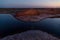 Dusk lake sunset in steppe on light background. Natural light. Sunset river water reflection