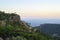 Dusk mountain landscape with views of the Mediterranean sea and cloudless sky. Golden hour, haze or fog.